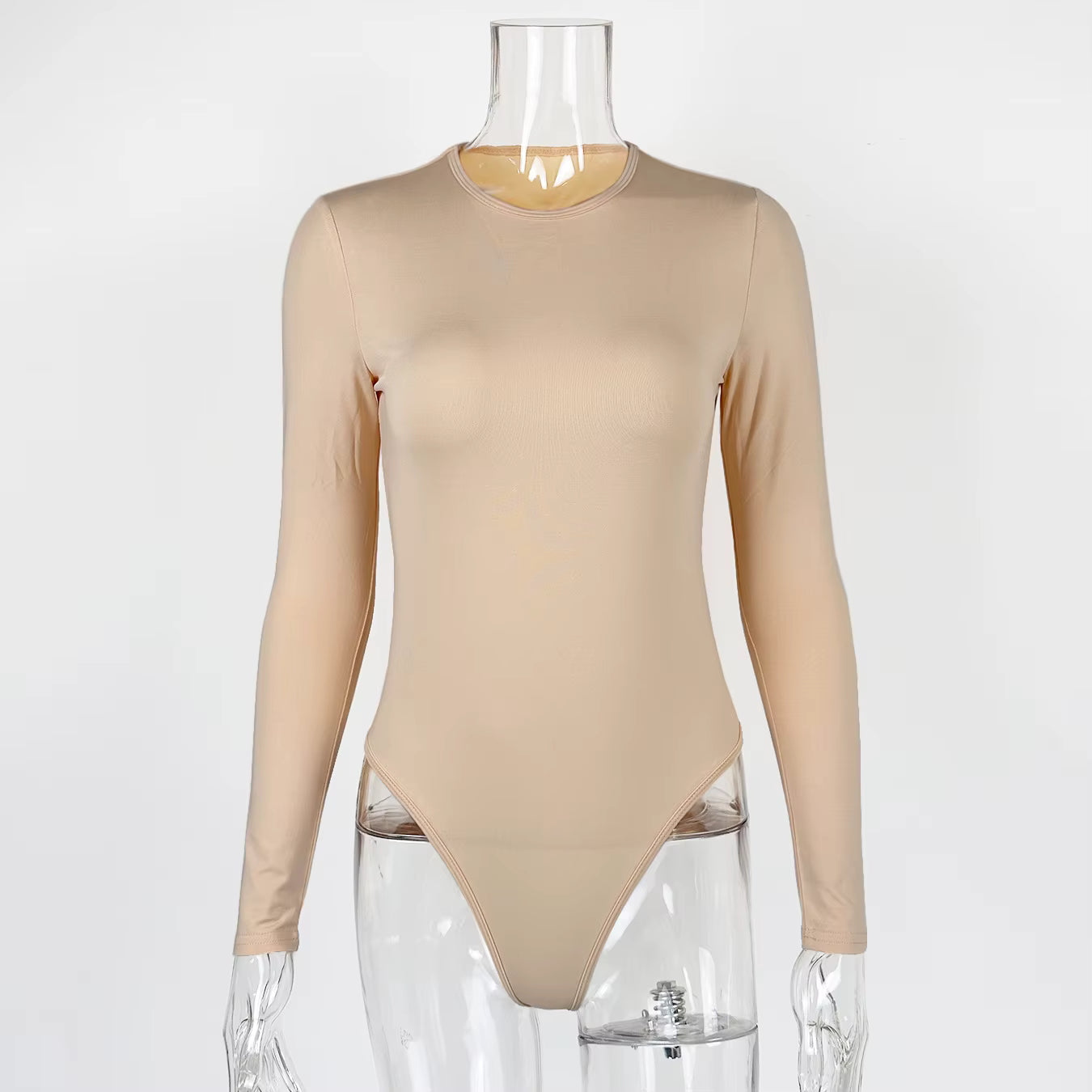 Long sleeve beige fabric bodysuit with a crew neck displayed on a clear plastic mannequin.